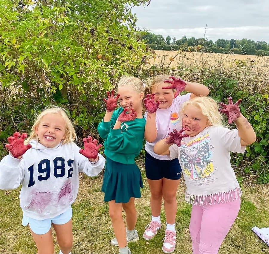 Campers showing off their paint-covered hands after an art session