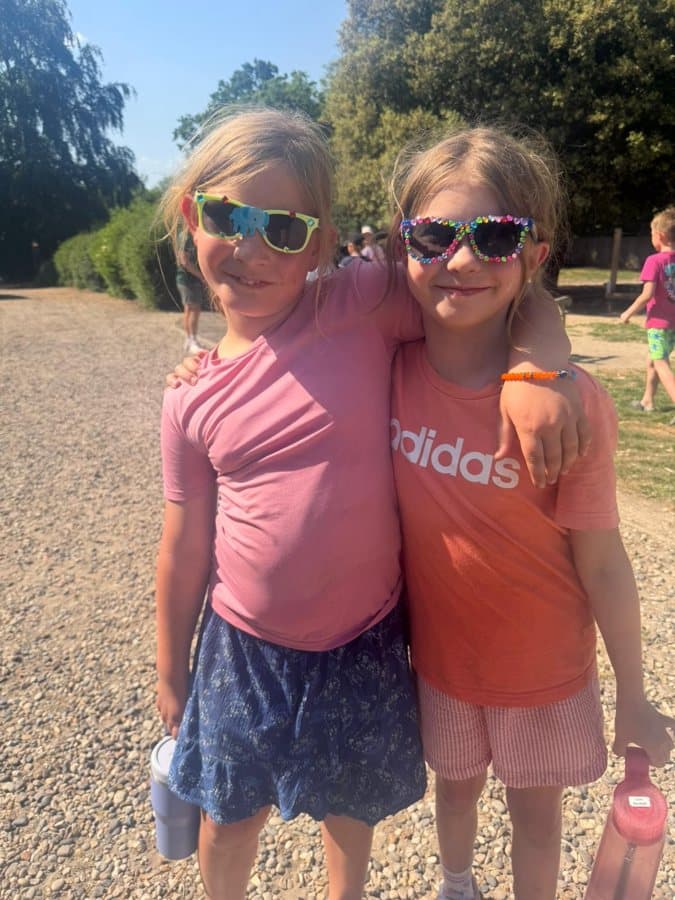 Two campers in sunglasses smiling at the end of the day