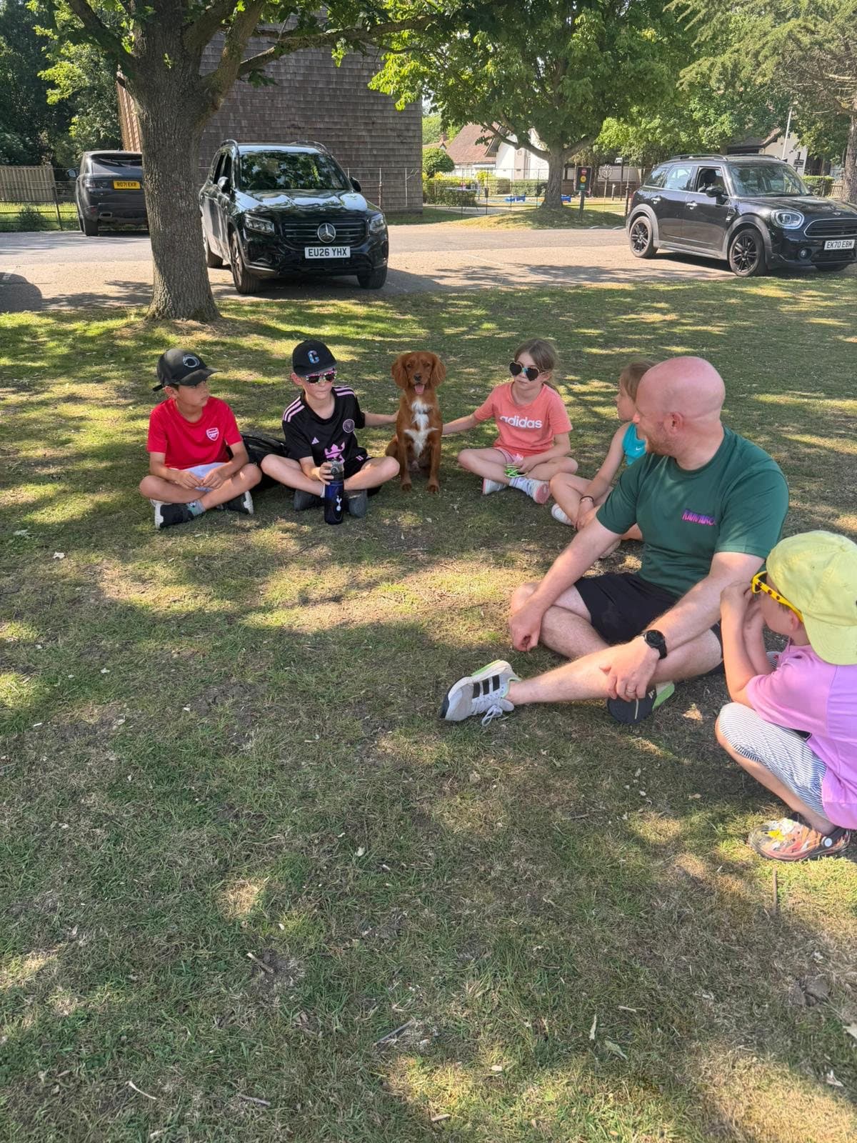 Kamparoo campers and a Roo Crew coach relaxing together as a group outdoors