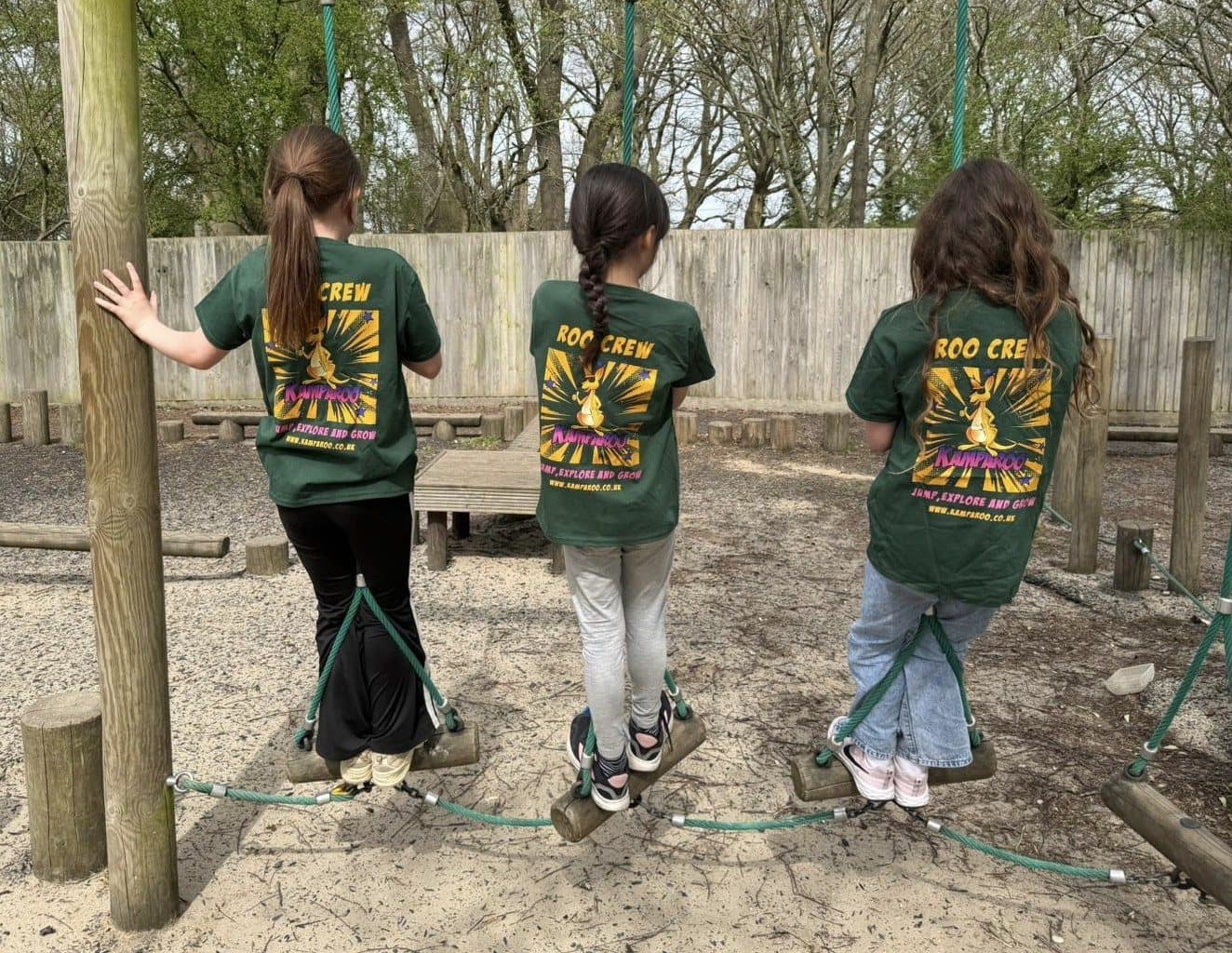 Campers in Roo Crew branded kit taking on an outdoor adventure course